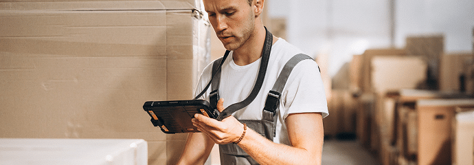 young-man-working-warehouse-with-boxes