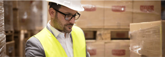 warehouse-worker-checking-parcels-with-bar-code-reader_342744-1569