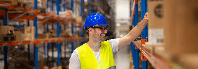 warehouse-worker-looking-shelves-with-packages-checking-inventory-large-warehouse-storage-distribution-area
